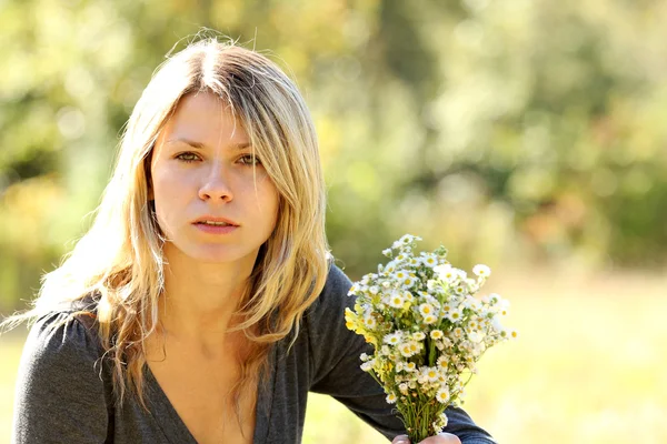 Young girl with flowers in nature — Stock Photo, Image