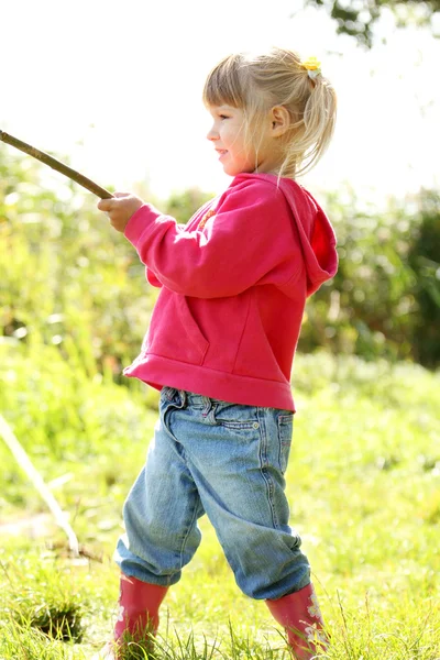 Beautiful little girl in rubber boots at the lake — Stock Photo, Image