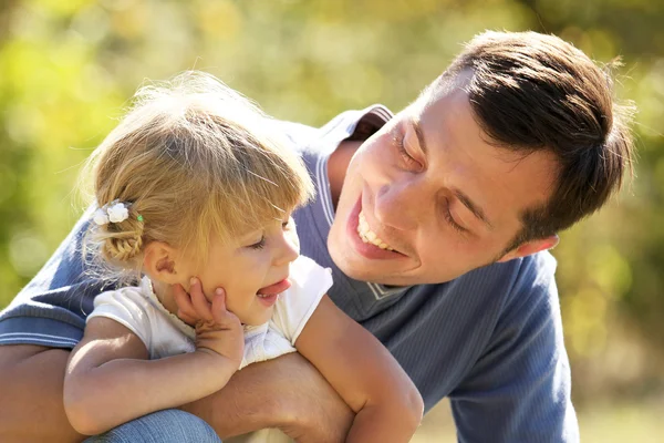 Beautiful little girl with her father in nature — Stock Photo, Image