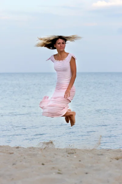 Girl jumping on beach Royalty Free Stock Images