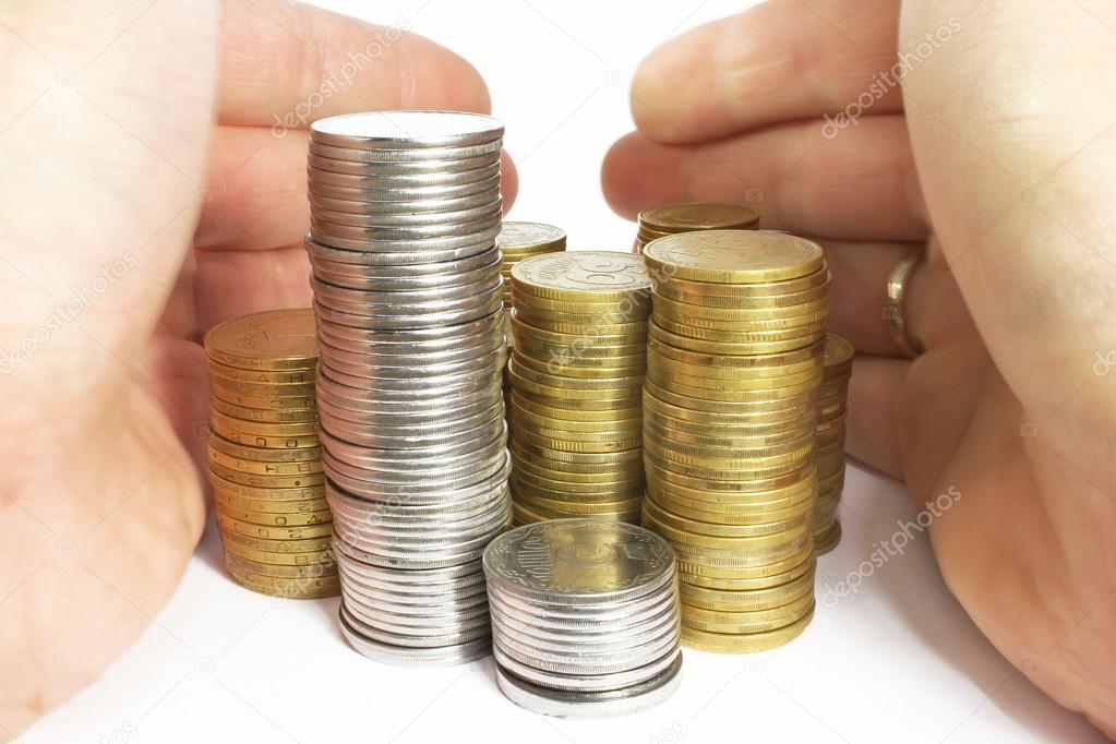 Hands and stacks of coins isolated