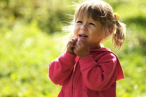 Beautiful little girl outdoors near a lake in rubber boots — Stock Photo, Image