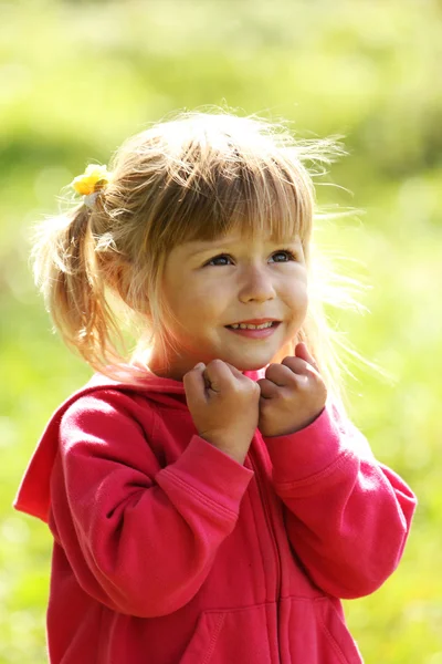 Beautiful little girl outdoors near a lake in rubber boots — Stock Photo, Image