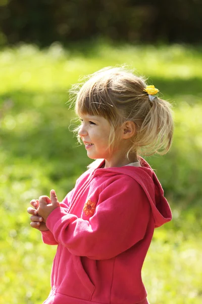 Beautiful little girl outdoors near a lake in rubber boots — Stock Photo, Image