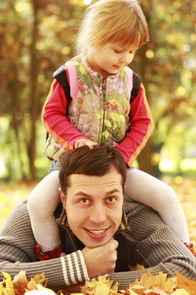 Beautiful little girl playing with her father in nature — Stock Photo, Image