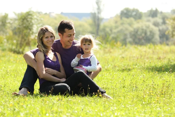 Young family in nature — Stock Photo, Image