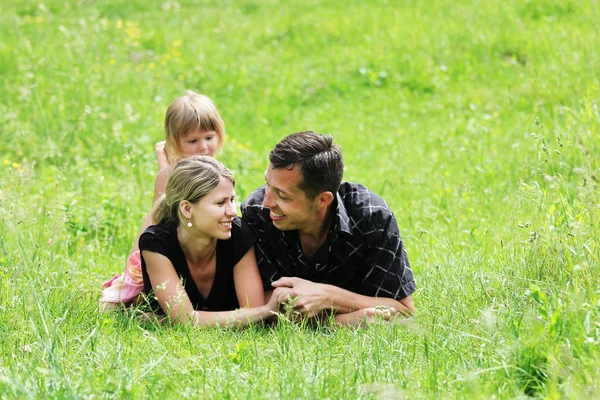 Couple in love with little daughter outdoors — Stock Photo, Image