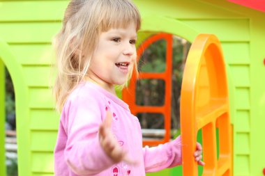 little girl with a children's playhouse clipart