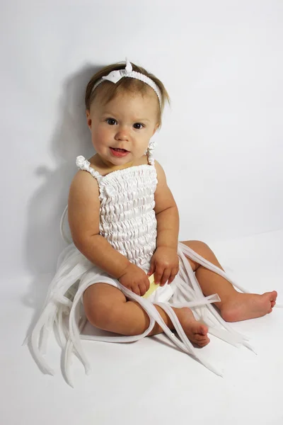 Little girl in the studio on a gray background — Stock Photo, Image