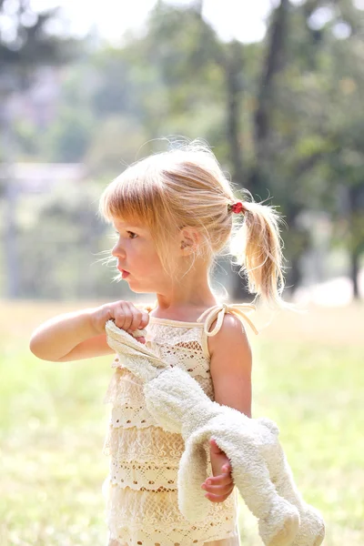 Beautiful little girl in nature with rabbits — Stock Photo, Image