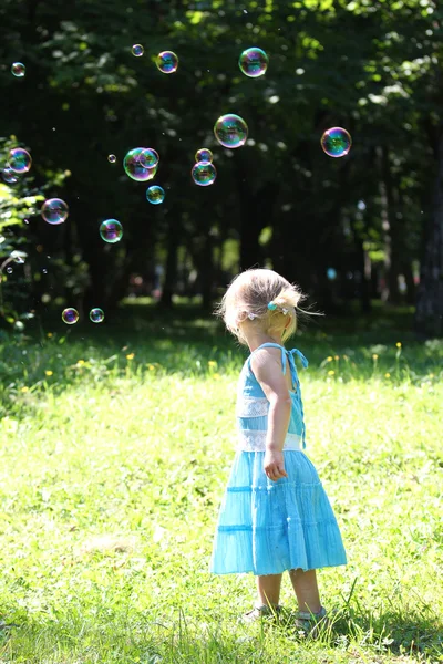 Little girl with soap bubbles Stock Photo