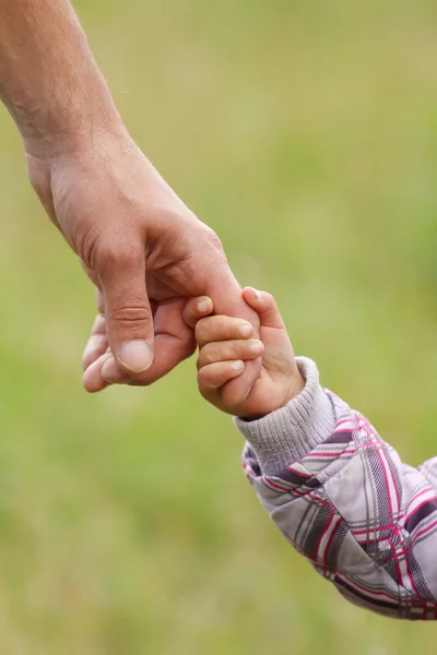 Parent tient la main d'un petit enfant — Photo