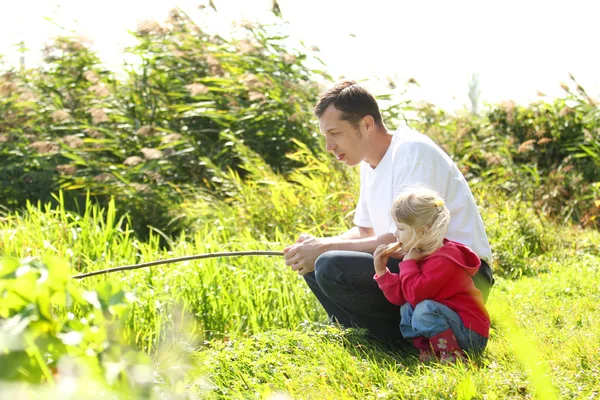 Pappa och lilla dotter nära en sjö — Stockfoto