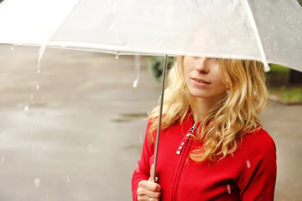 A woman with an umbrella in the rain — Stock Photo, Image