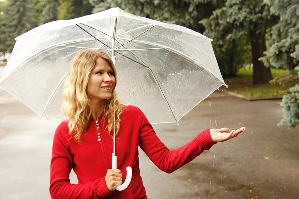 A woman with an umbrella in the rain — Stock Photo, Image