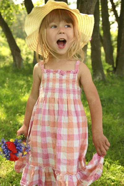 Beautiful little girl in a hat on the nature — Stock Photo, Image