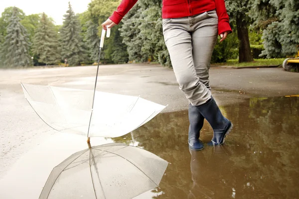 A man with an umbrella in his boots and puddle — Stock Photo, Image