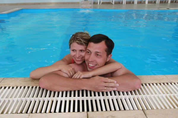 Loving couple in the water pool — Stock Photo, Image