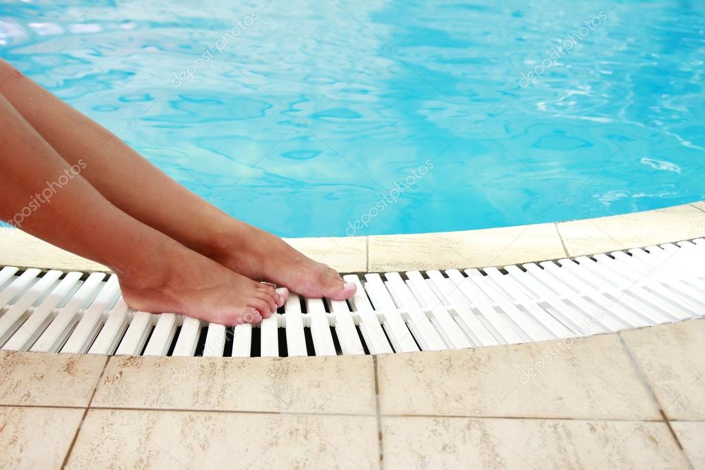 female legs in the water pool