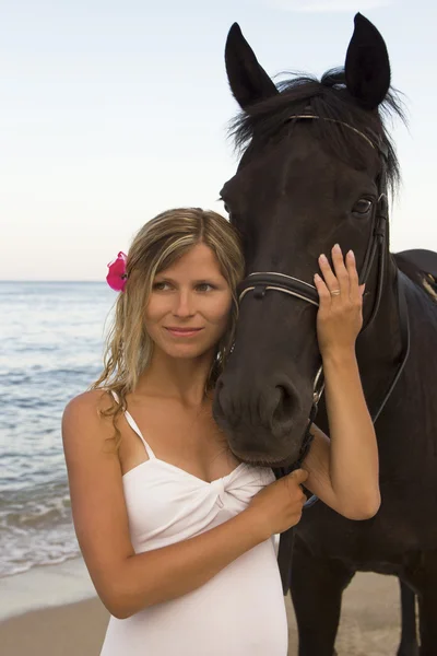 Girl with a horse by the sea — Stock Photo, Image