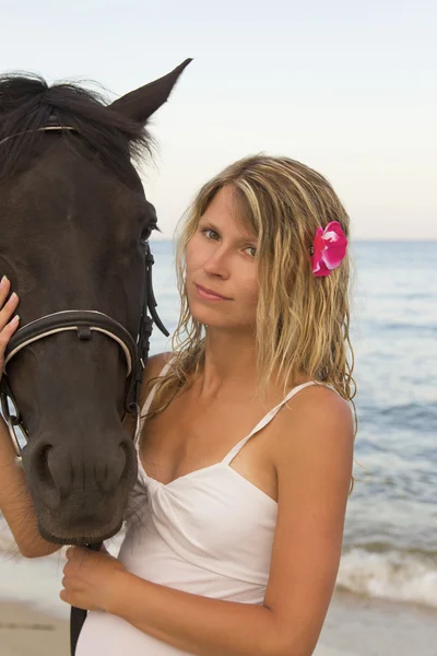 Menina com um cavalo à beira-mar — Fotografia de Stock