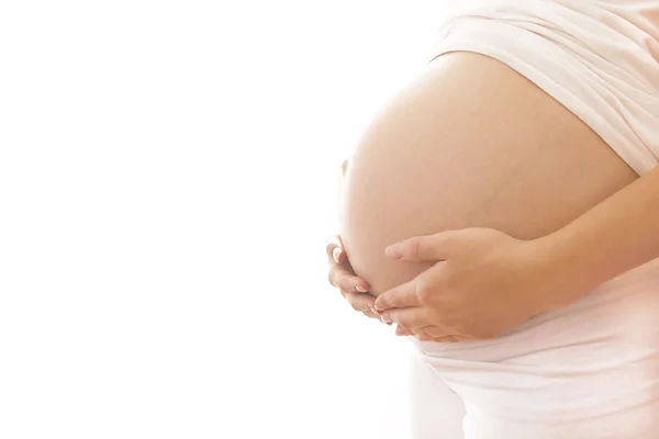 Těhotná žena na bílém pozadí — Stock fotografie