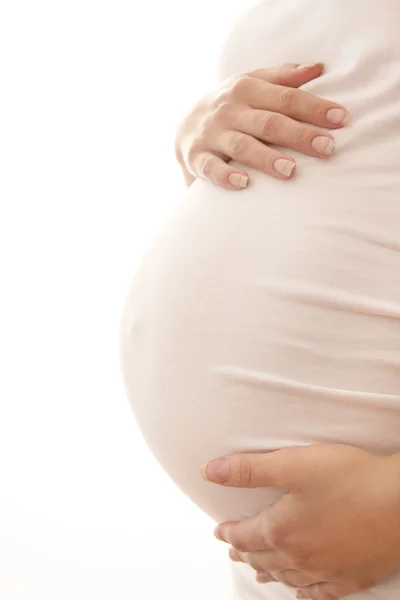 A mulher grávida em um fundo branco — Fotografia de Stock
