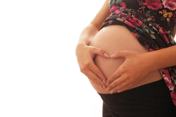 La donna incinta su uno sfondo bianco , — Foto Stock
