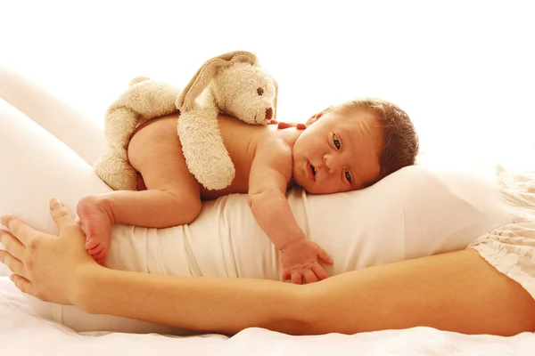 Newborn baby lying on his mom Stock Picture