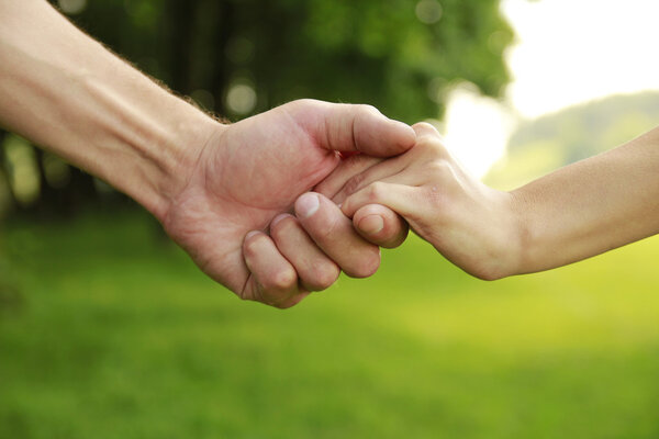 two hands in love couple on nature 