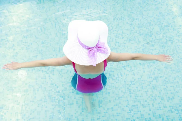 Dziewczyna w basenie woda w kapeluszu — Zdjęcie stockowe