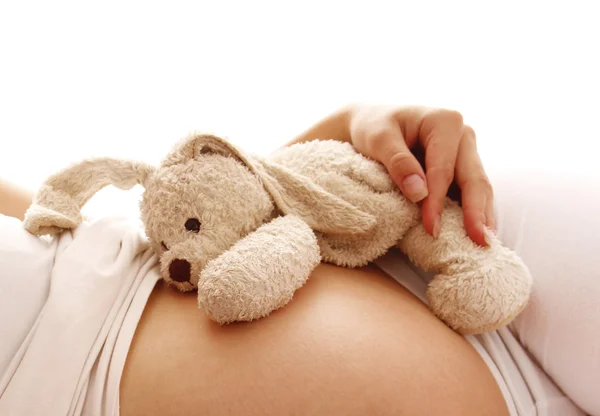 Stomach pregnant woman with toy — Stock Photo, Image