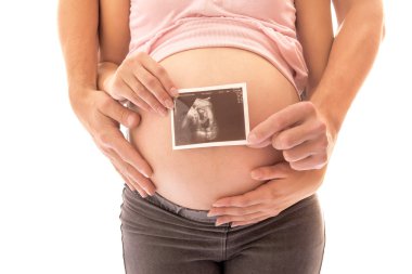 Pregnant couple with ultrasound image clipart