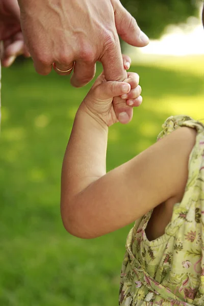 Ouder houdt de hand van een klein kind — Stockfoto