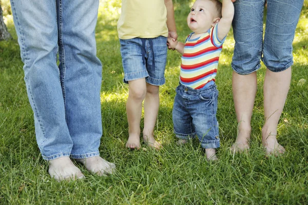 Family feet in jeans — Stock Photo, Image