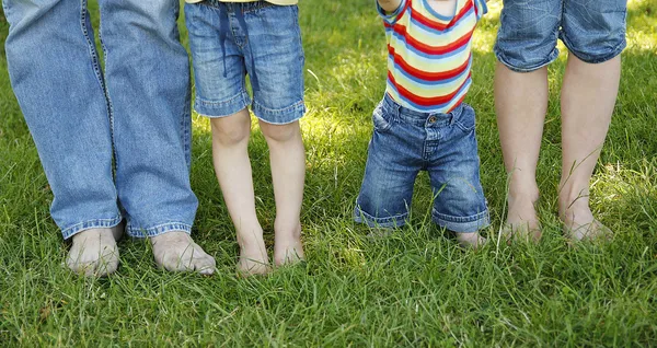 Family feet in jeans — Stock Photo, Image