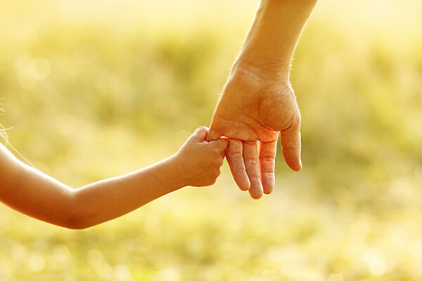 Parent holds child's hand