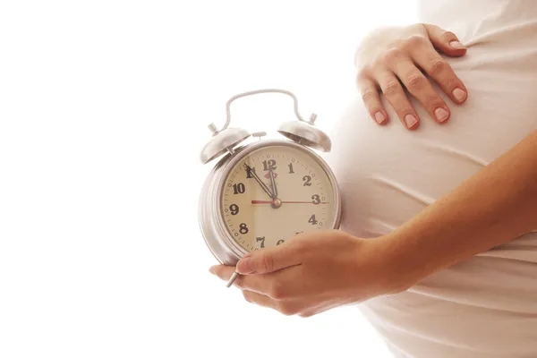 Pregnant woman with alarm clock — Stock Photo, Image