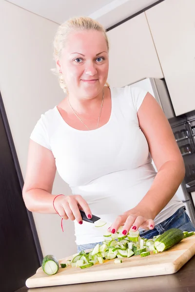 A stout woman in the kitchen Royalty Free Stock Photos