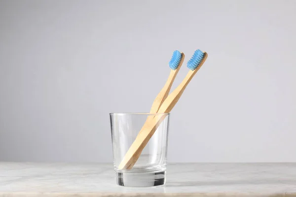 Lgbt Concept Two Light Blue Bamboo Toothbrushes Glass Copy Space — Stock Photo, Image