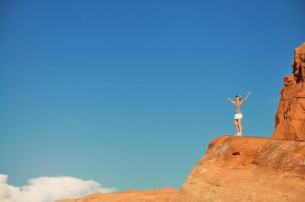 Girl on orange rock — Stock Photo, Image