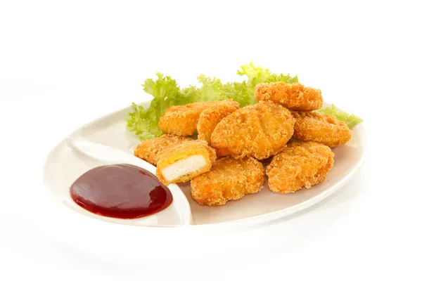 Plate of nuggets with dip sauce, one nugget cut — Stock Photo, Image