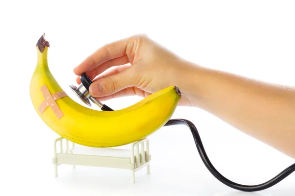 Banaani saa hoitoa sairaalassa sängyssä — kuvapankkivalokuva