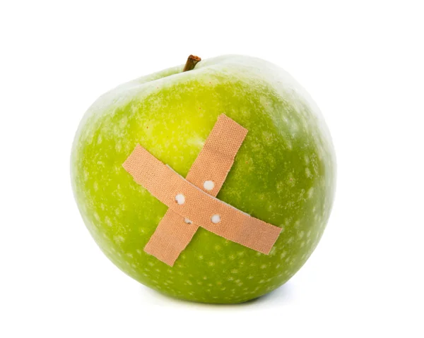 Apple with plaster against white background — Stock Photo, Image