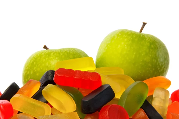 Choose: pile of candy or two apples — Stock Photo, Image