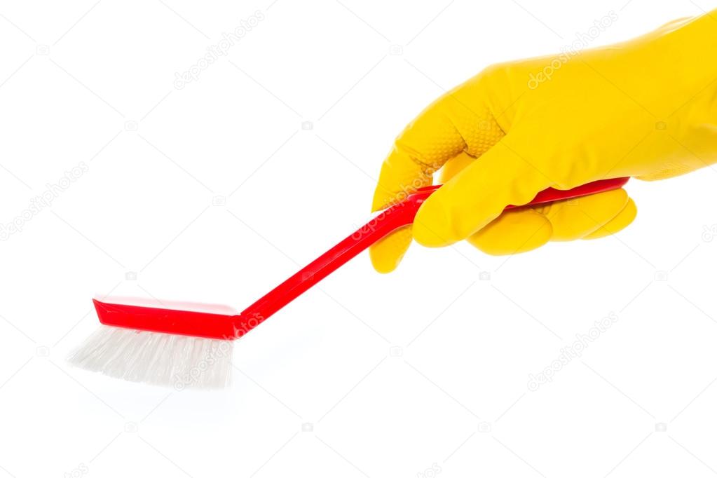 Hand in rubber glove with red dishwashing brush