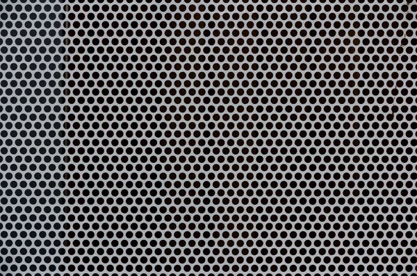 Background of gray metal with holes — Stock Photo, Image