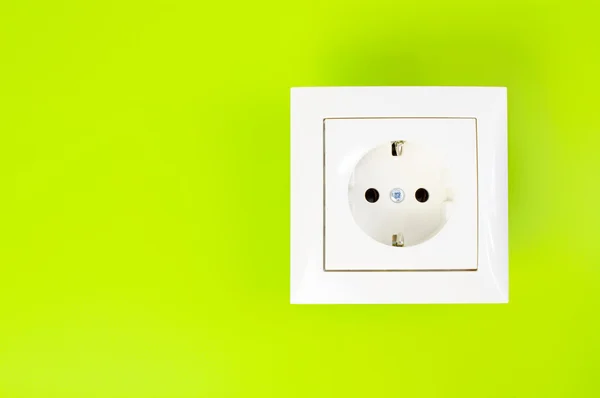 White power socket on green background — Stock Photo, Image