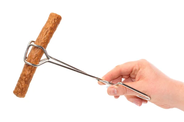 Dutch fast food snack frikandel in frying tongs — Stock Photo, Image