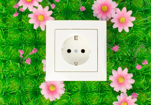 Power outlet on the green grass — Stockfoto